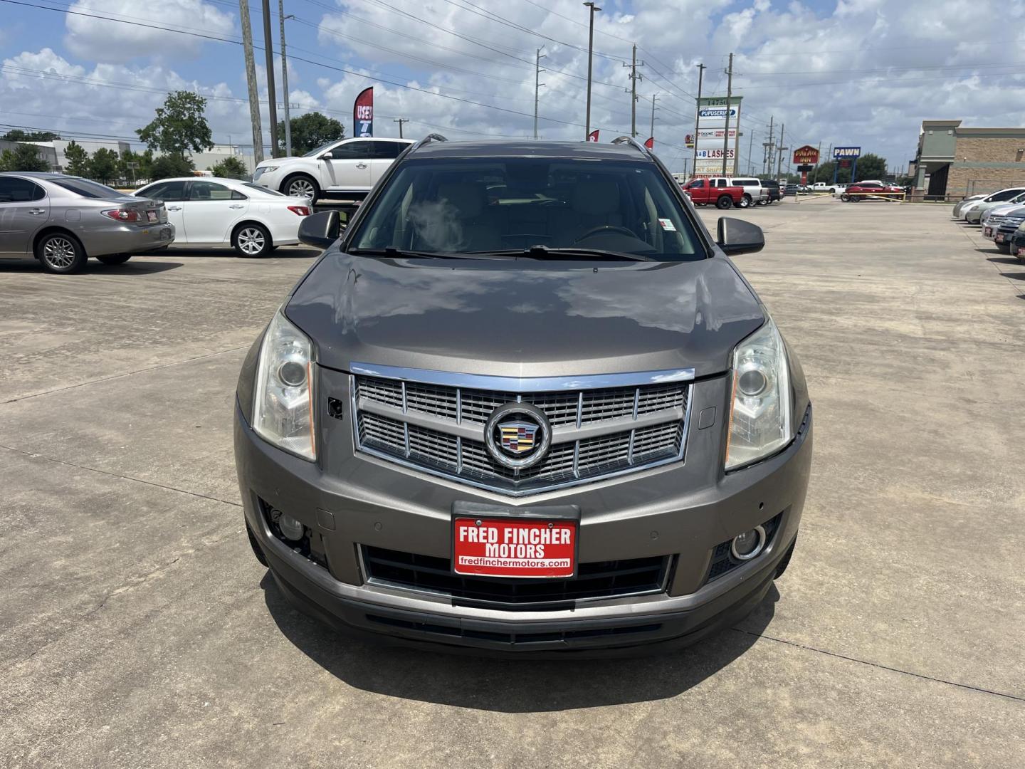 2012 Brown /Tan Cadillac SRX Performance (3GYFNBE39CS) with an 3.6L V6 DOHC 24V FFV engine, 6-Speed Automatic transmission, located at 14700 Tomball Parkway 249, Houston, TX, 77086, (281) 444-2200, 29.928619, -95.504074 - Photo#1