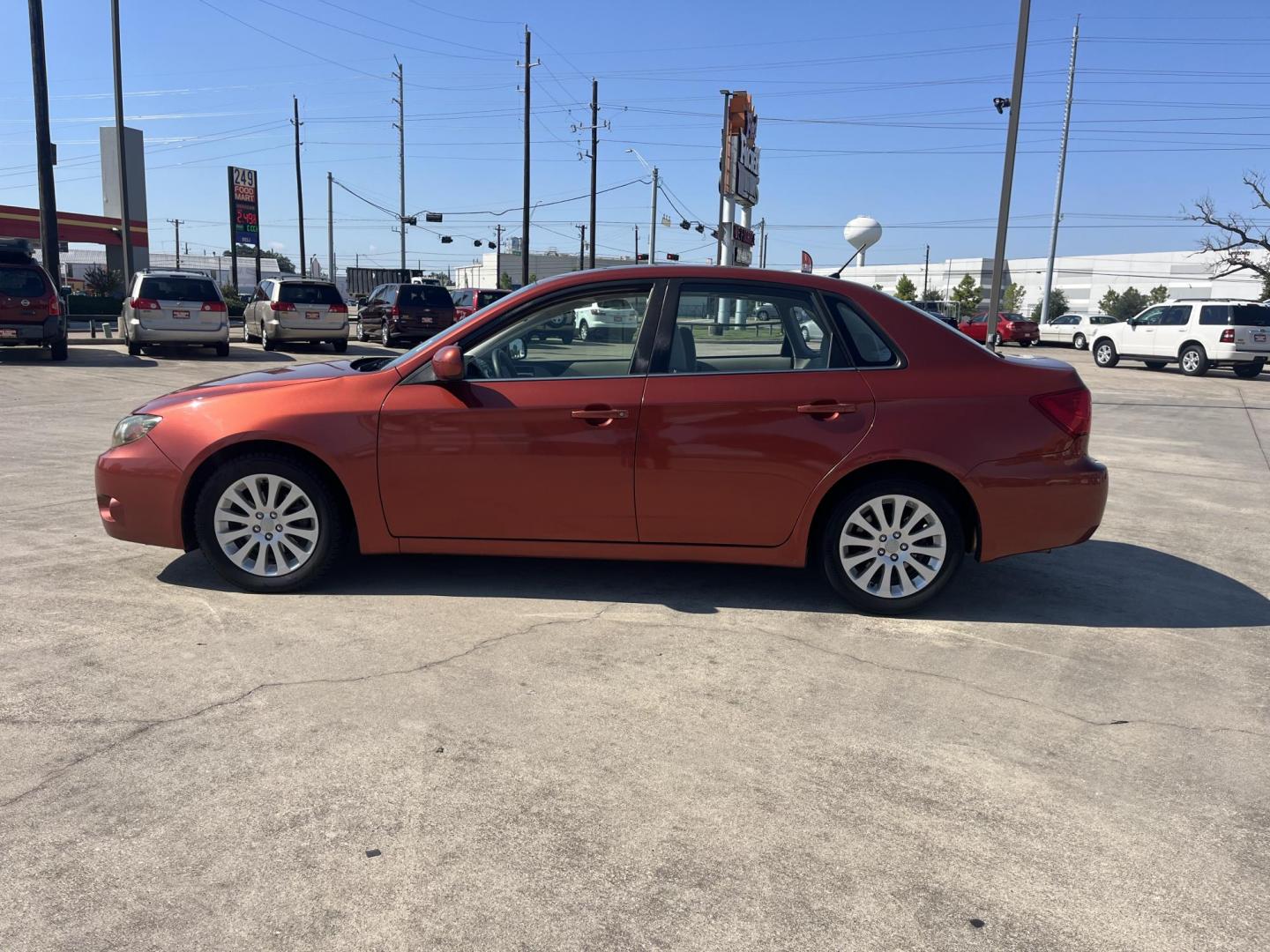 2010 Orange Subaru Impreza 2.5i Premium 4-Door (JF1GE6B60AH) with an 2.5L H4 SOHC 16V engine, Auto transmission, located at 14700 Tomball Parkway 249, Houston, TX, 77086, (281) 444-2200, 29.928619, -95.504074 - Photo#3