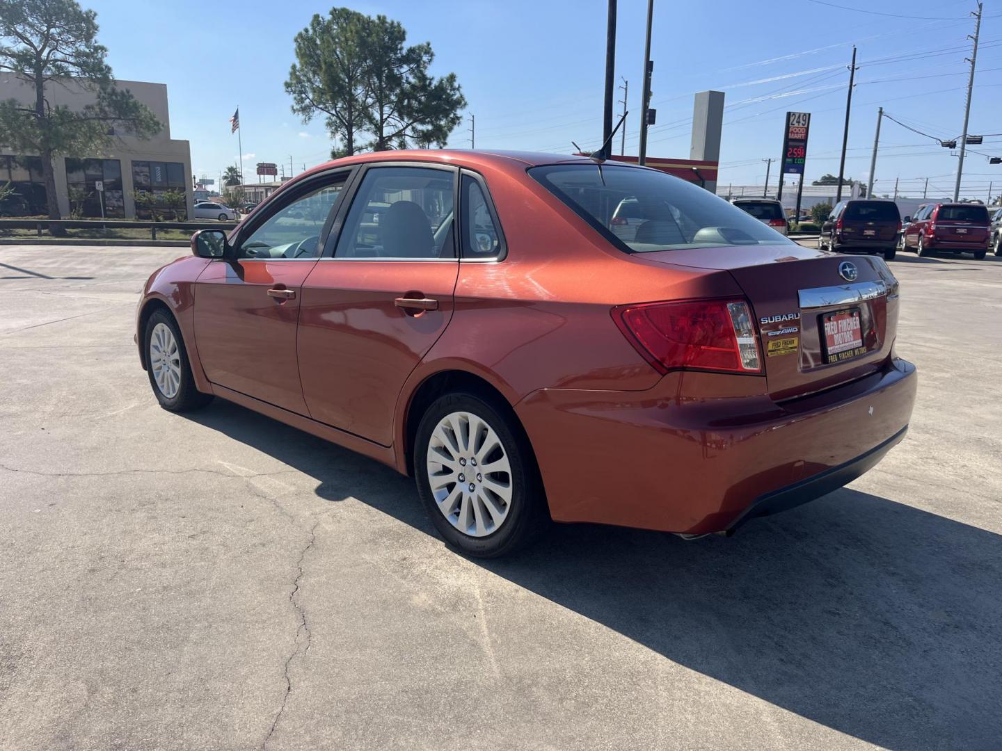 2010 Orange Subaru Impreza 2.5i Premium 4-Door (JF1GE6B60AH) with an 2.5L H4 SOHC 16V engine, Auto transmission, located at 14700 Tomball Parkway 249, Houston, TX, 77086, (281) 444-2200, 29.928619, -95.504074 - Photo#4