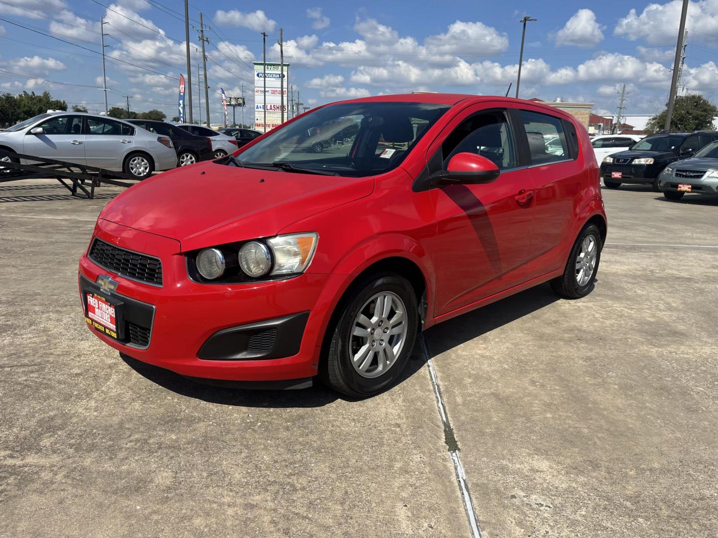 2015 red Chevrolet Sonic LT Auto 5-Door (1G1JC6SH3F4) with an 1.8L L4 DOHC 24V engine, 6-Speed Automatic transmission, located at 14700 Tomball Parkway 249, Houston, TX, 77086, (281) 444-2200, 29.928619, -95.504074 - Photo#2