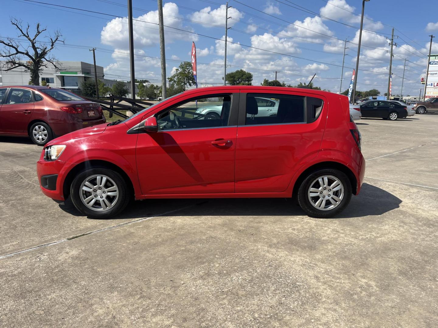 2015 red Chevrolet Sonic LT Auto 5-Door (1G1JC6SH3F4) with an 1.8L L4 DOHC 24V engine, 6-Speed Automatic transmission, located at 14700 Tomball Parkway 249, Houston, TX, 77086, (281) 444-2200, 29.928619, -95.504074 - Photo#3