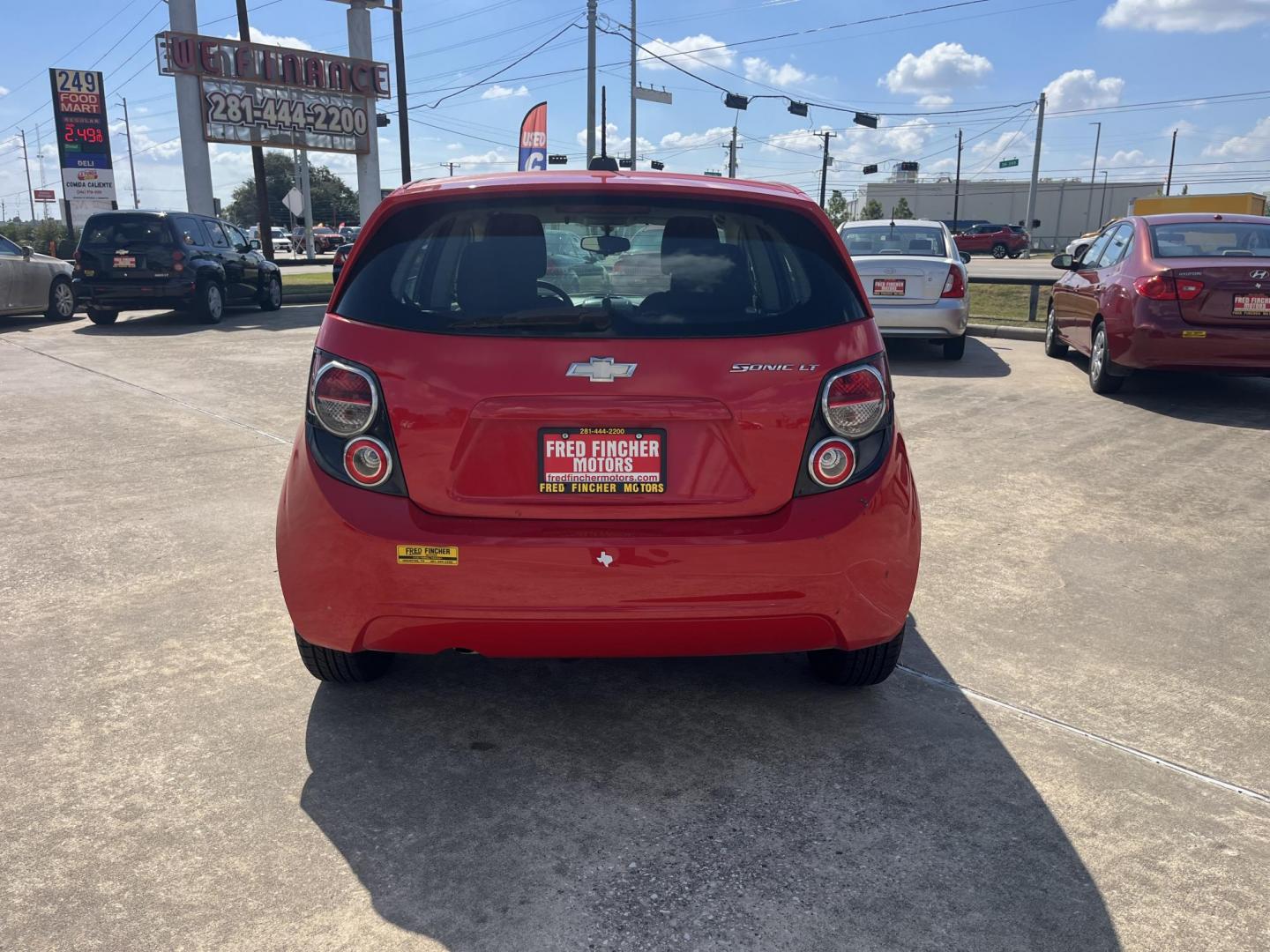 2015 red Chevrolet Sonic LT Auto 5-Door (1G1JC6SH3F4) with an 1.8L L4 DOHC 24V engine, 6-Speed Automatic transmission, located at 14700 Tomball Parkway 249, Houston, TX, 77086, (281) 444-2200, 29.928619, -95.504074 - Photo#5
