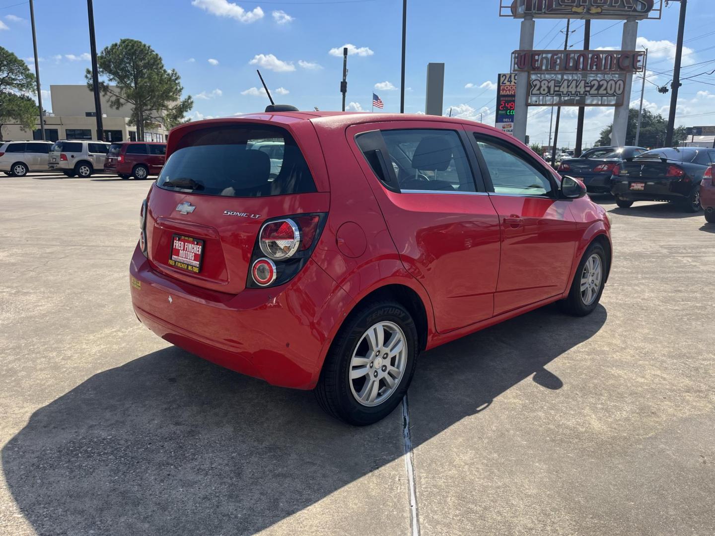 2015 red Chevrolet Sonic LT Auto 5-Door (1G1JC6SH3F4) with an 1.8L L4 DOHC 24V engine, 6-Speed Automatic transmission, located at 14700 Tomball Parkway 249, Houston, TX, 77086, (281) 444-2200, 29.928619, -95.504074 - Photo#6