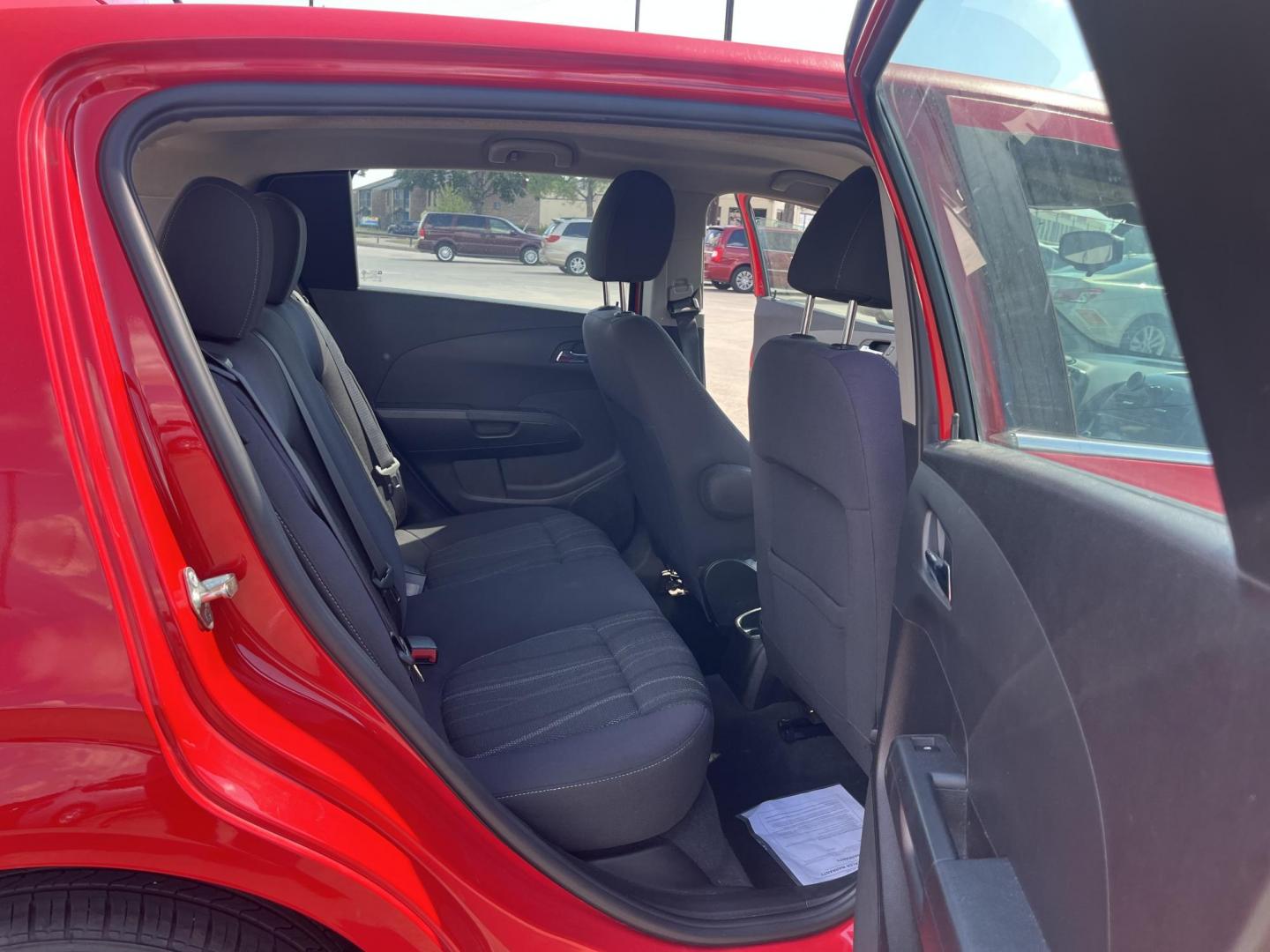 2015 red Chevrolet Sonic LT Auto 5-Door (1G1JC6SH3F4) with an 1.8L L4 DOHC 24V engine, 6-Speed Automatic transmission, located at 14700 Tomball Parkway 249, Houston, TX, 77086, (281) 444-2200, 29.928619, -95.504074 - Photo#12