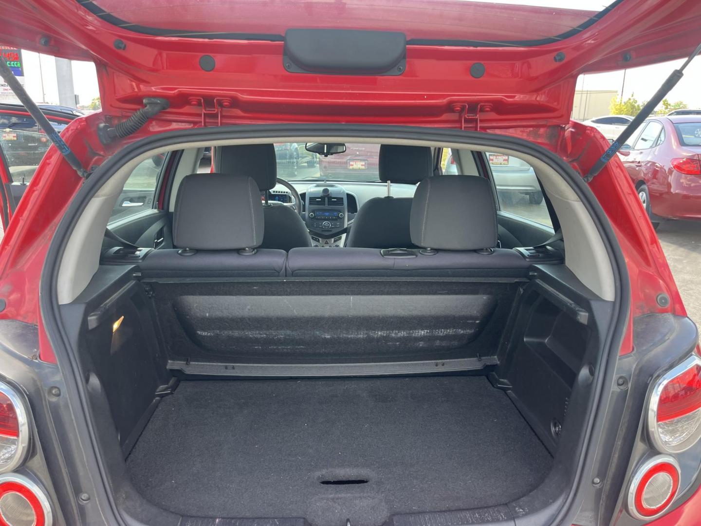 2015 red Chevrolet Sonic LT Auto 5-Door (1G1JC6SH3F4) with an 1.8L L4 DOHC 24V engine, 6-Speed Automatic transmission, located at 14700 Tomball Parkway 249, Houston, TX, 77086, (281) 444-2200, 29.928619, -95.504074 - Photo#13