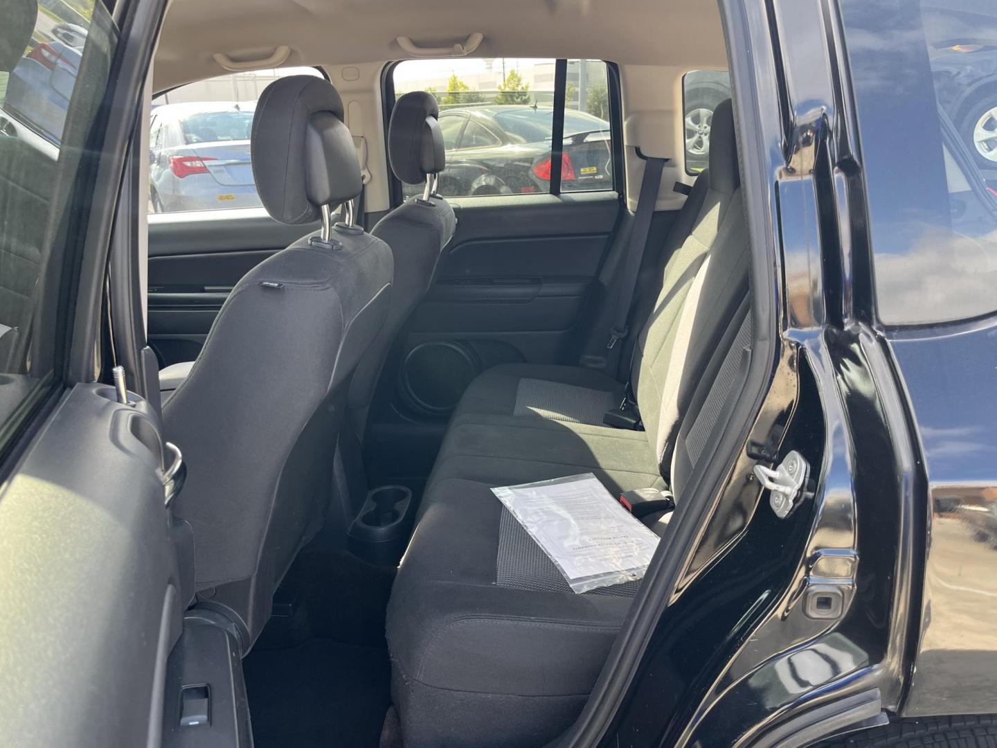 2014 black Jeep Compass Sport FWD (1C4NJCBAXED) with an 2.0L L4 DOHC 16V engine, located at 14700 Tomball Parkway 249, Houston, TX, 77086, (281) 444-2200, 29.928619, -95.504074 - Photo#9